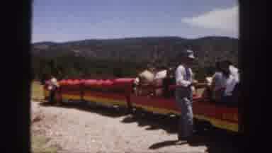 Colorado (1958): Person Wearing Blue Shirt Inspects Red And Yellow Tour Train
