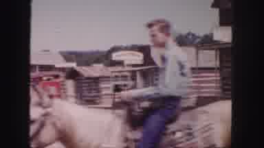 Colorado (1958): Man Rides Horse Down A Road In What Looks Like A Western Themed