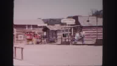 Colorado (1958): Wooden Building Has Some People Moving About And Enjoying The Sun