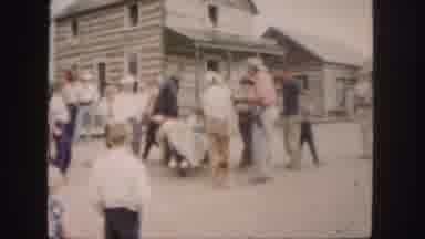 Colorado (1958): Group Of Men And Boys Gather Around Seemingly Sick Person In