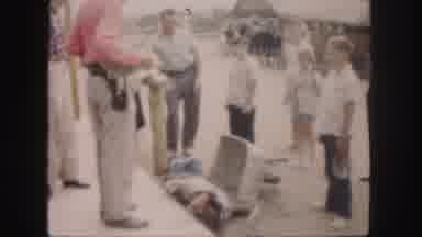 Colorado (1958): People Picking Injured Person From Ground On A Clear Day