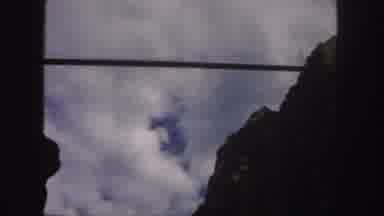 Colorado (1958): Viewing A Blue Sky Filled With Clouds Drifting Over A Rocky