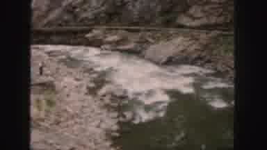 Colorado (1958): People Watching Rapid Flowing River On A Bright Sunny Day