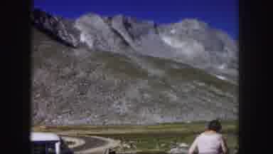 Colorado USA (1958): Woman Wearing A White Dress Walking Near Mountains In A