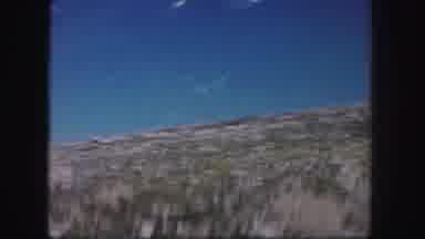 Colorado USA (1958): Car Driving By While Watching A Guy Walking Around A Craggy