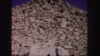 Colorado USA (1958): Woman Standing Below The Peak Of A Mountain