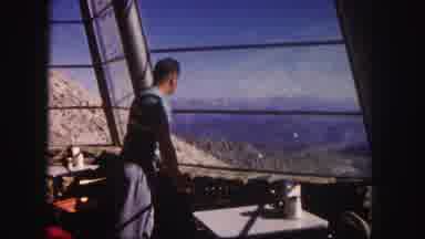 Colorado USA (1958): A Man In Some Type Of Vehicle With A Mountain View