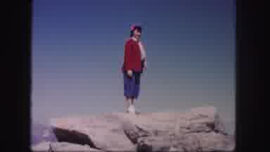 Colorado USA (1958): Person Wearing Red Sweater Stands On Rock On A Bright Sunny