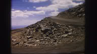 Colorado USA (1958): A Dirt Rocky Hill With A Blue Cloudy Sky In The Background