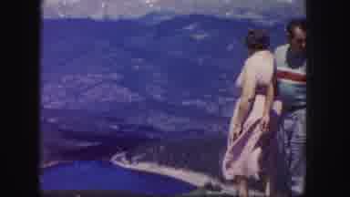 Colorado USA (1958): Woman Wearing White Dress Looks At Mountain Valley Lake On A