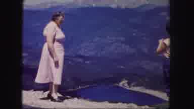 Colorado USA (1958): Woman Wearing Pink Dress Looks At Mountain Valley Lake On A