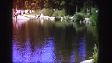 Colorado USA (1958): A Lake And A Man And Woman Sitting At A Picnic Table In Front