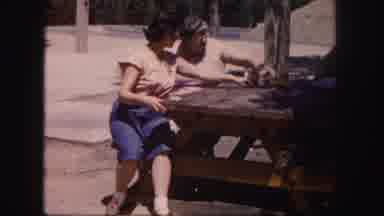 Colorado USA (1958): Women Sit At A Wooden Table Outside Their Home For A Happy