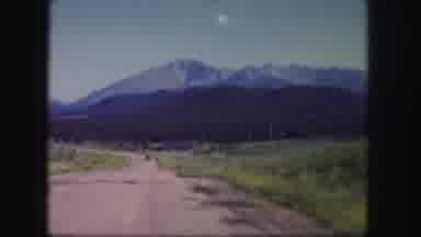 Colorado USA (1958): A Person Down An Isolated Road With High Mountain Peaks