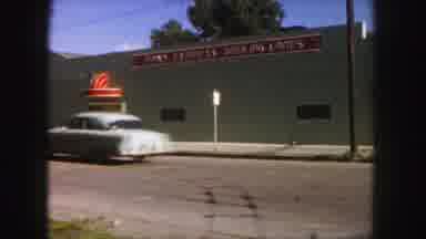 Denver Colorado (1958): Vintage Cars Drive Down The Road And Park By A Brick