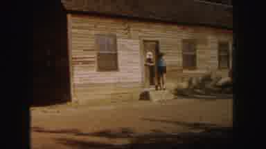 Denver Colorado (1958): Woman Walking Down Stairs Away From Old Wood House Door As
