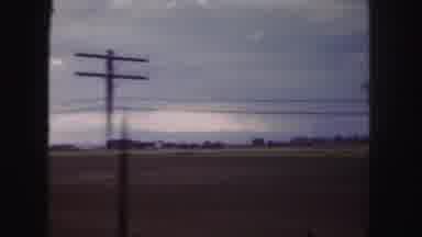 Denver Colorado (1958): Passing Plains And Electrical Poles With Sign At The End