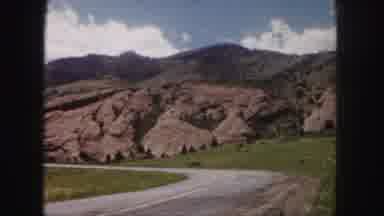 Denver Colorado (1958): A View Of Trees And Mountains Crossed By A Road And Also