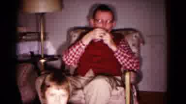 Hagerstown Maryland USA (1958): Man Smoking Pipe In Chair Cuts To Women Laughing