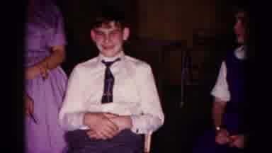 Hagerstown Maryland USA (1958): Woman Wearing Purple Dress Combs Hair Of Boy