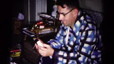 Hagerstown Maryland USA (1958): Male In Flannel Robe Shows An Electronic Device