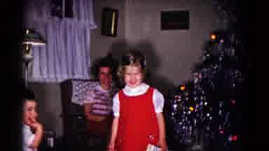 Hagerstown Maryland USA (1958): A Small Red Dressed Girl Standing Near Christmas
