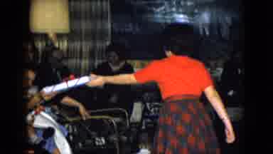Las Vegas USA (1958): Woman Red Shirt Hands Gift To Woman Holding Baby In Lap