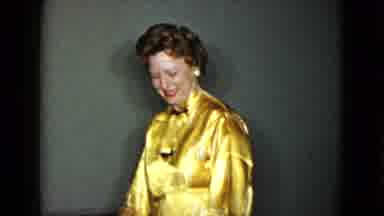 Las Vegas USA (1958): Well-Dressed Woman In Gold Blouse Holds A Cigarette And