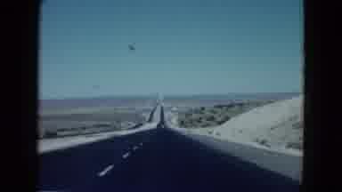 Las Vegas USA (1958): Driving On A Black Top Two Lane Road In The Desert With