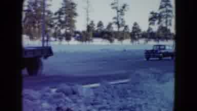 Las Vegas USA (1958): Vehicles Traveling Down A Snowy Highway With Trees In The