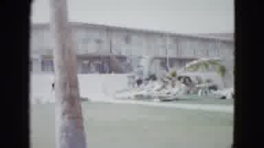 Las Vegas USA (1958): People Walking Past White Fence And Building On A Clear Day