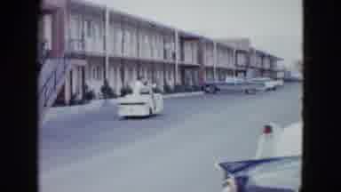 Las Vegas USA (1958): Man Drives Woman Around In Cart Outside Of Motel Woman Sits