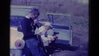 Omaha Nebraska USA (1958): Man Wearing Tan Jacket Makes Faces While Eating