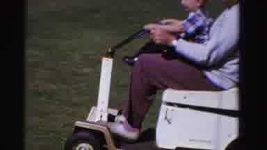 Ontario Canada (1958): Kid Riding Scooter Outside With Grandfather