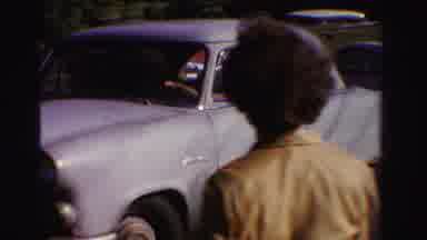 Ontario Canada (1958): A Person Backing Up A Car And A View Of The Bushes