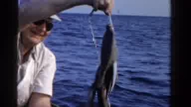 Ontario Canada (1958): Older Man In A Boat On The Ocean Proudly Holding Up The