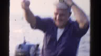 Ontario Canada (1958): Man Blue Shirt Fixing Hat Sitting On Boat Man White Shirt