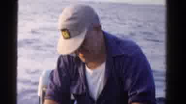 Ontario Canada (1958): A Fisher On A Boat Trying To Take Off The Hook Of The Mouth