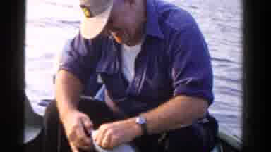 Ontario Canada (1958): A Man Is Sitting On The Boat And Catching Fish