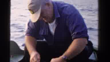 Ontario Canada (1958): A Man On A Boat Getting His Bait Ready For Fishing
