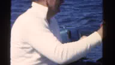 Ontario Canada (1958): Man Fishing In Boat Reels In What Appears To Be A Fish