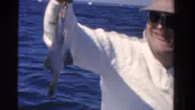 Ontario Canada (1958): A Man With Glasses And A Hat Sits In A Boat In The Ocean