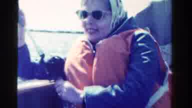 Ontario Canada (1958): Woman Wearing Red Life Vest Holds Fishing Pole On A Bright