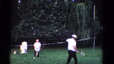 Ontario Canada (1958): Man Plays With His Son In Outdoor Area With Rackets And
