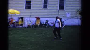 Ontario Canada (1958): A Man Participates A Racket Game In The Backyard At A
