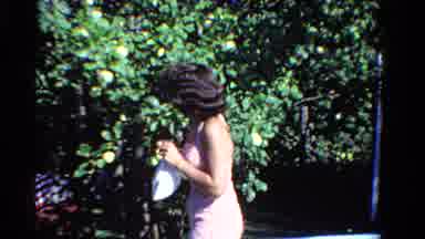 Ontario Canada (1958): Woman Wearing Pink Shorts Stands In Pool On A Bright Sunny
