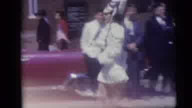 Camden New Jersey USA (1959): Majorette Wearing White Dress Marches Past Red Car