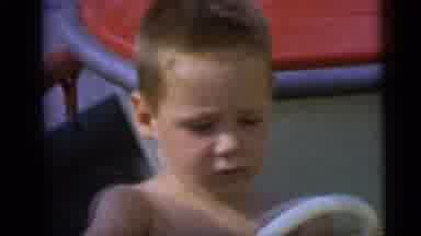 Camden New Jersey USA (1959): A Young Boy And Girl Ride A Carousel Of Cars At An