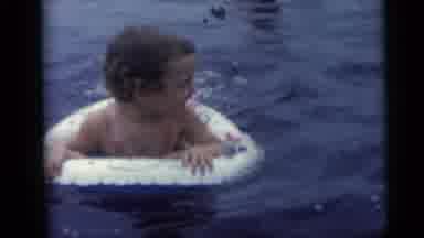 Camden New Jersey USA (1959): Child In Inflatable Inner Tube Smiles And Looks