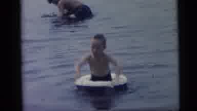 Camden New Jersey USA (1959): Little Boy In Doughnut Float Enjoys Splashing In The